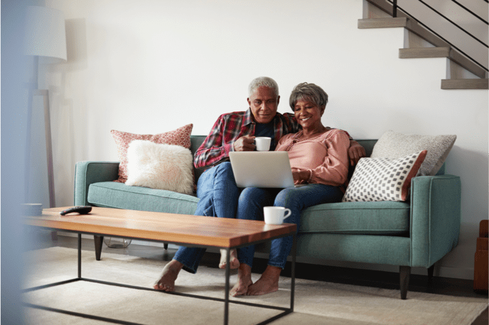 happy couple on couch drinking coffee