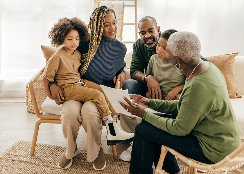 Three-generation family at home discussing their estate plan